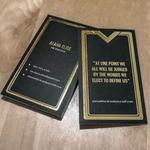 Premium uncoated black business card featuring an elegant gold foil border and sophisticated typography, subtly reflecting highlights.