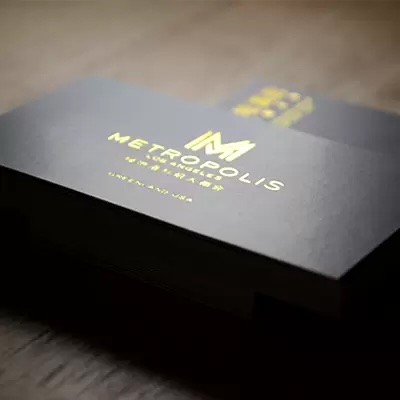 Stack of uncoated business cards with gold foil accents, displaying a clean and premium presentation for professional branding