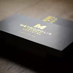 Stack of uncoated business cards with gold foil accents, displaying a clean and premium presentation for professional branding
